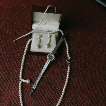 a pearl necklace and a pair of scissors