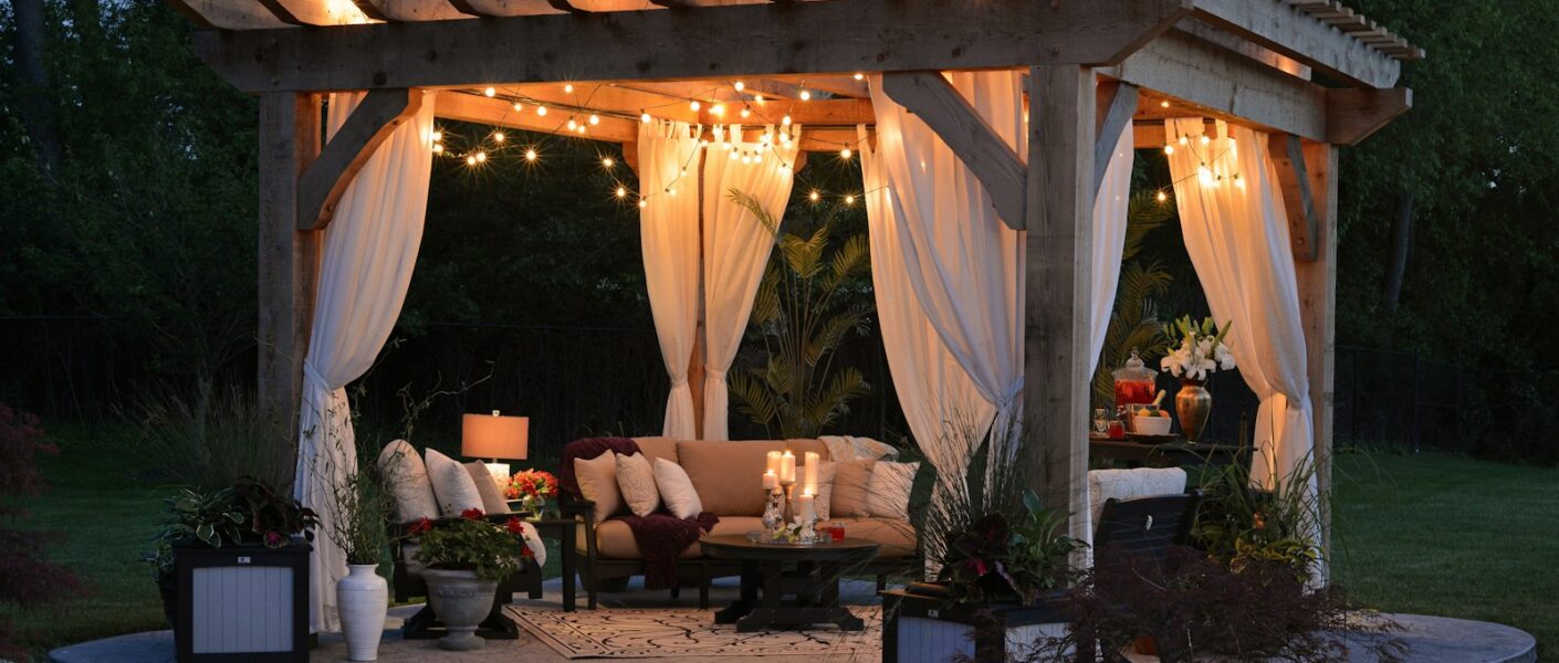 photo of gazebo with curtain and string lights